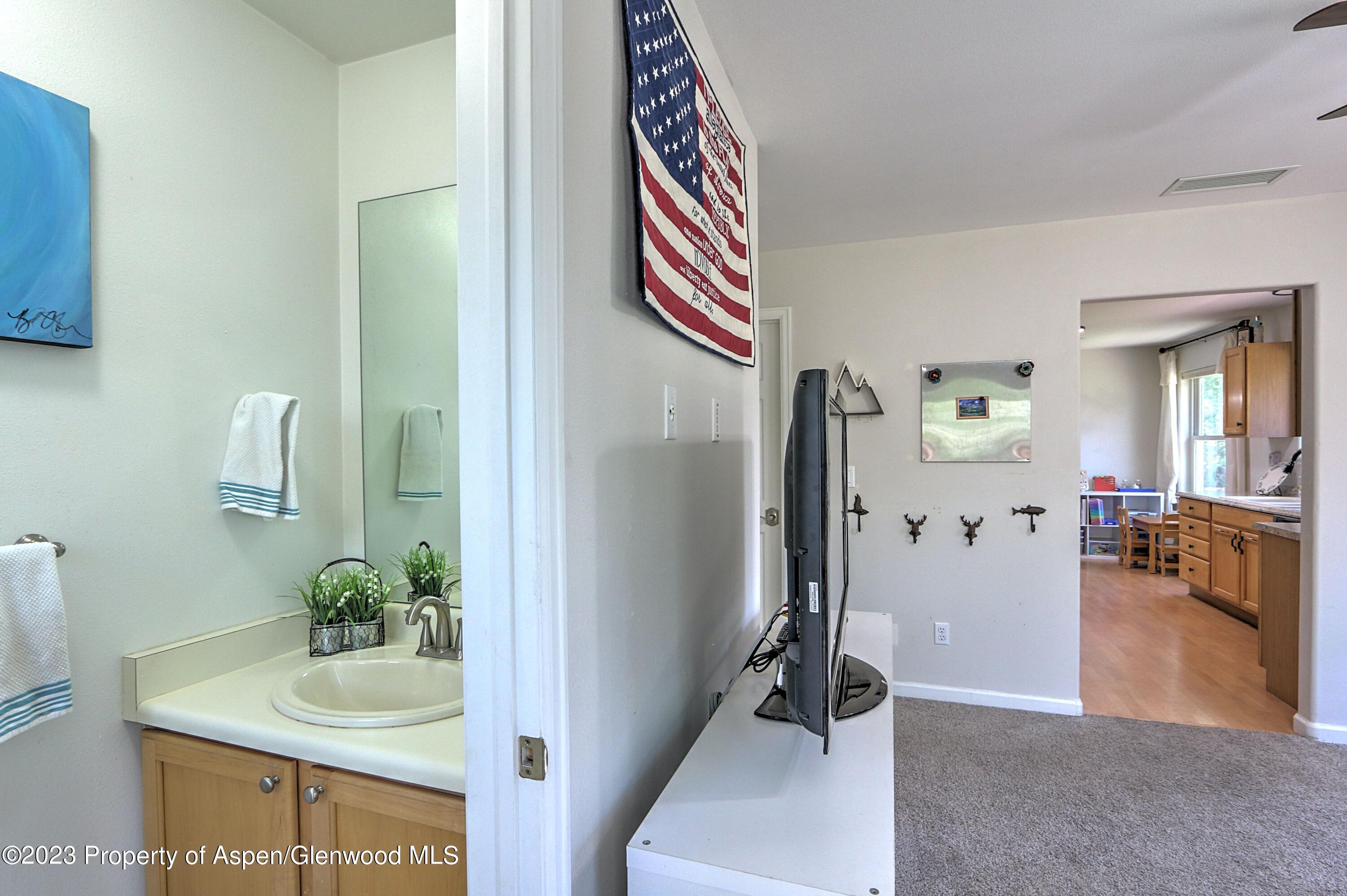 1527 Graham Court Rifle, CO 81650 - Photo 17 of 32 a bathroom with a sink and a mirror