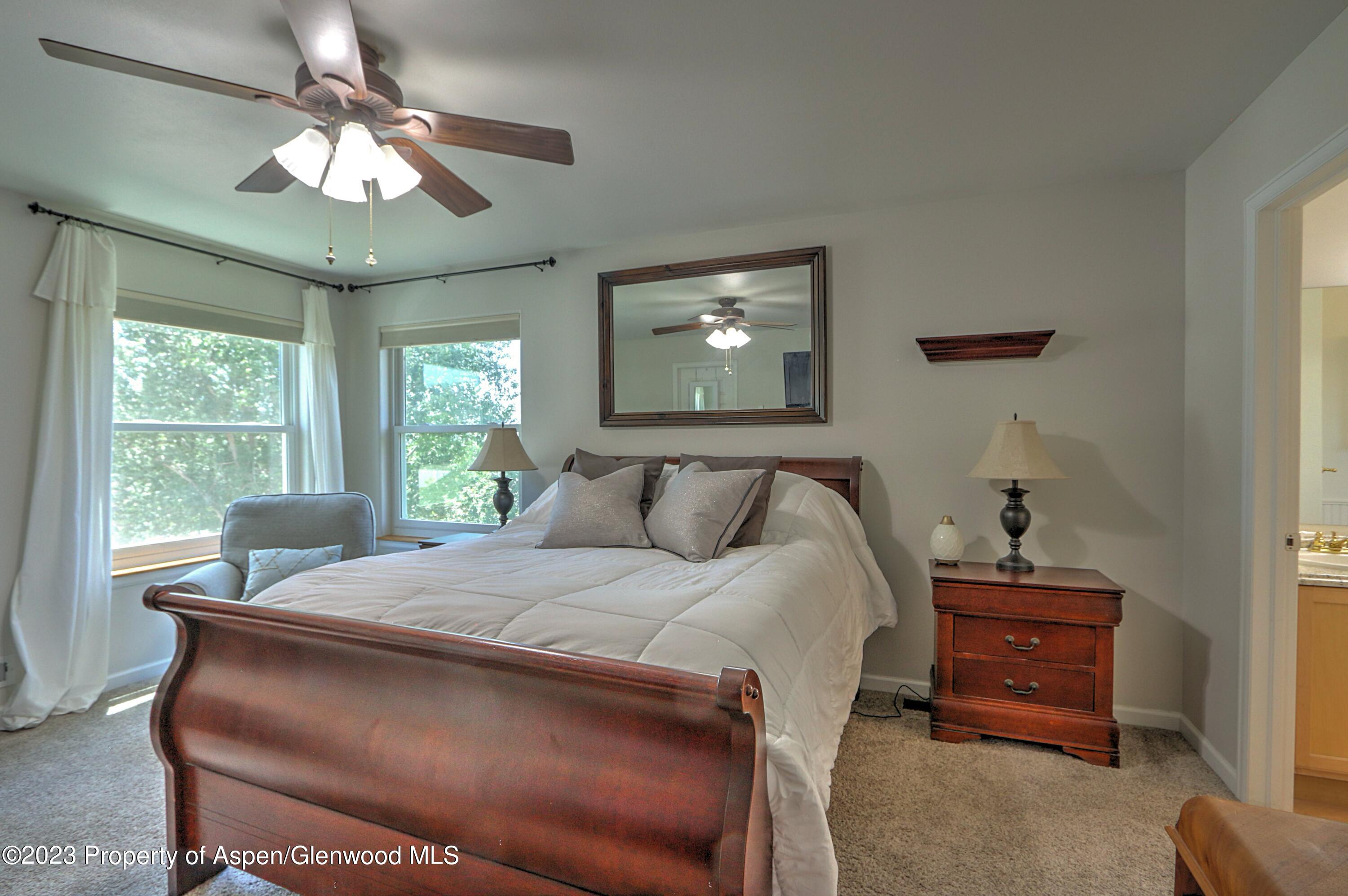 1527 Graham Court Rifle, CO 81650 - Photo 18 of 32 a bedroom with a bed and a chandelier