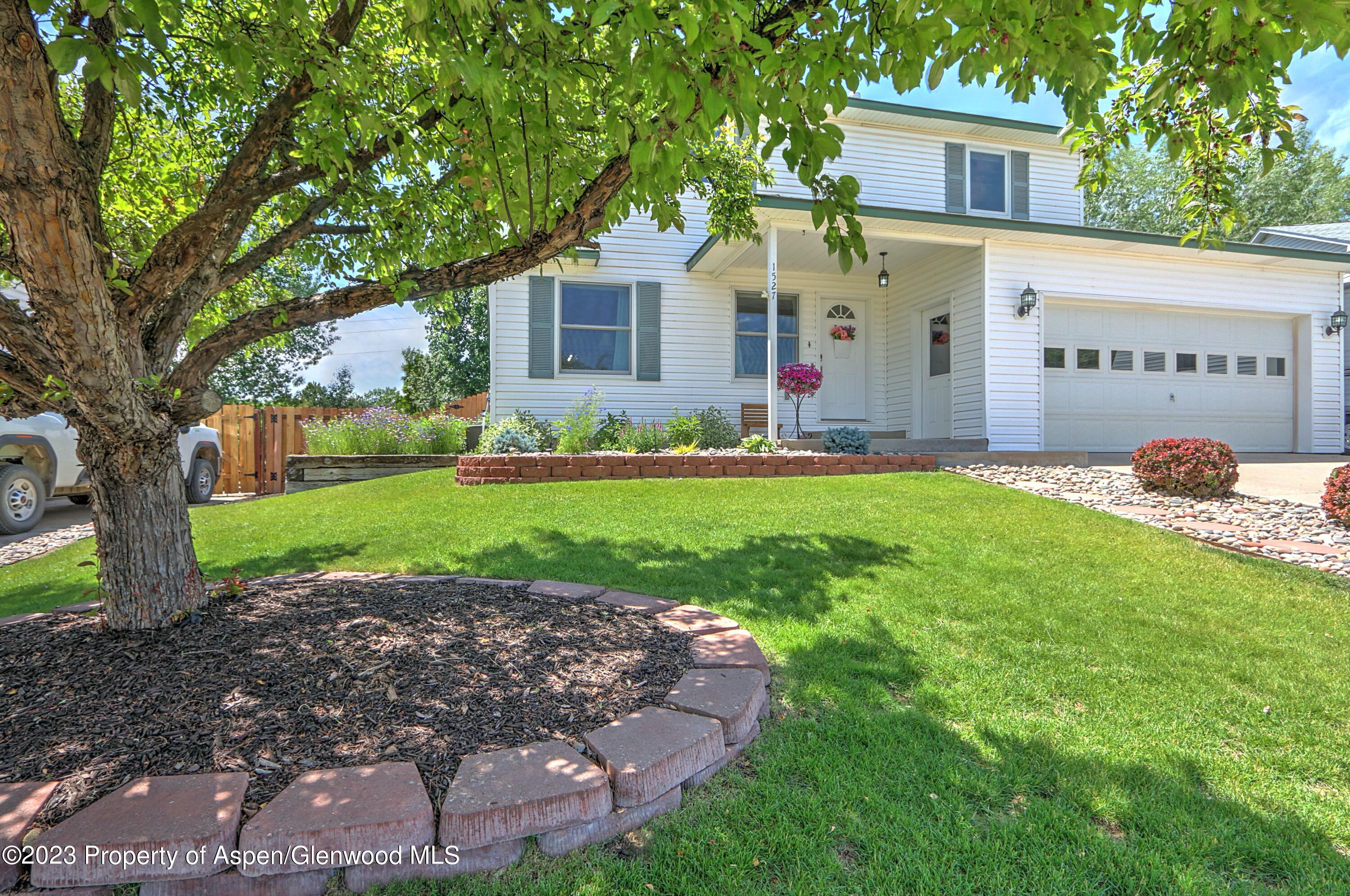 1527 Graham Court Rifle, CO 81650 - Photo 2 of 32 a front view of a house with a yard and garage
