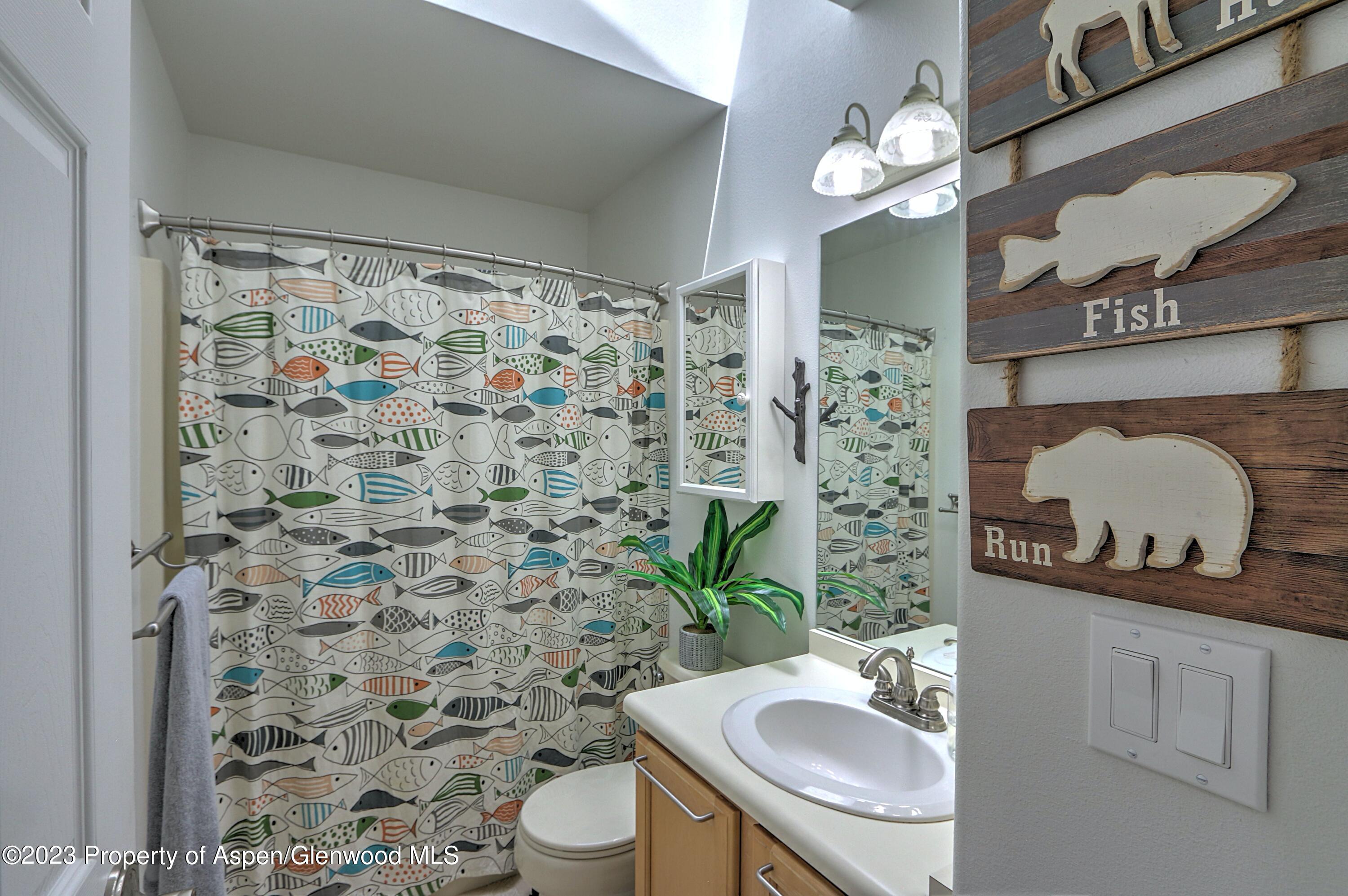1527 Graham Court Rifle, CO 81650 - Photo 25 of 32 a bathroom with a sink toilet and shower