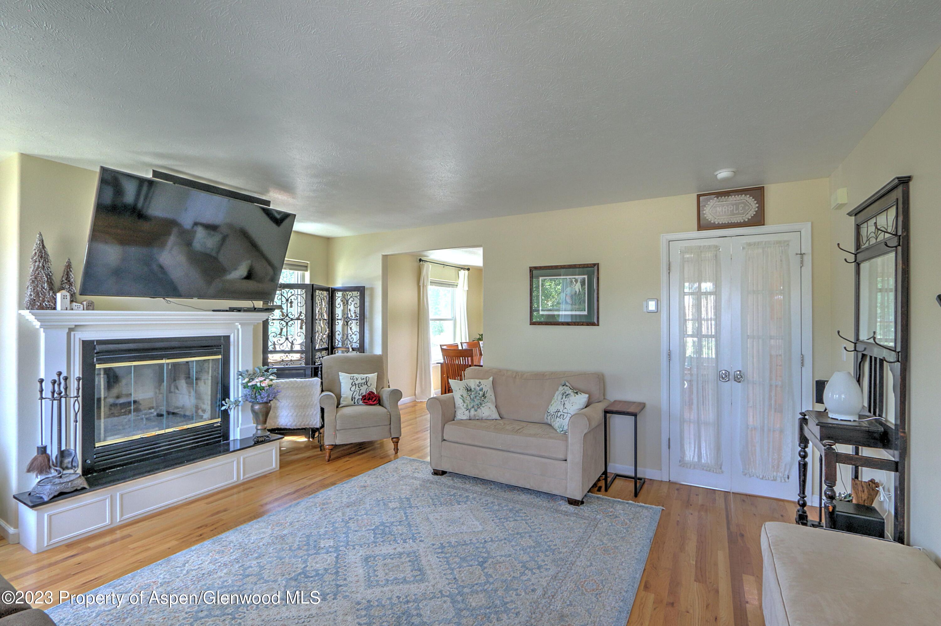 1527 Graham Court Rifle, CO 81650 - Photo 8 of 32 a living room with furniture and a fireplace