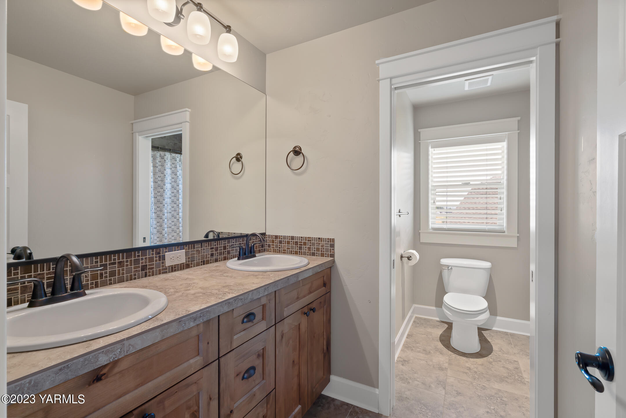 2978 Crosswater Loop Richland, WA 99354 - Photo 23 of 34 a bathroom with a granite countertop sink a toilet and a mirror