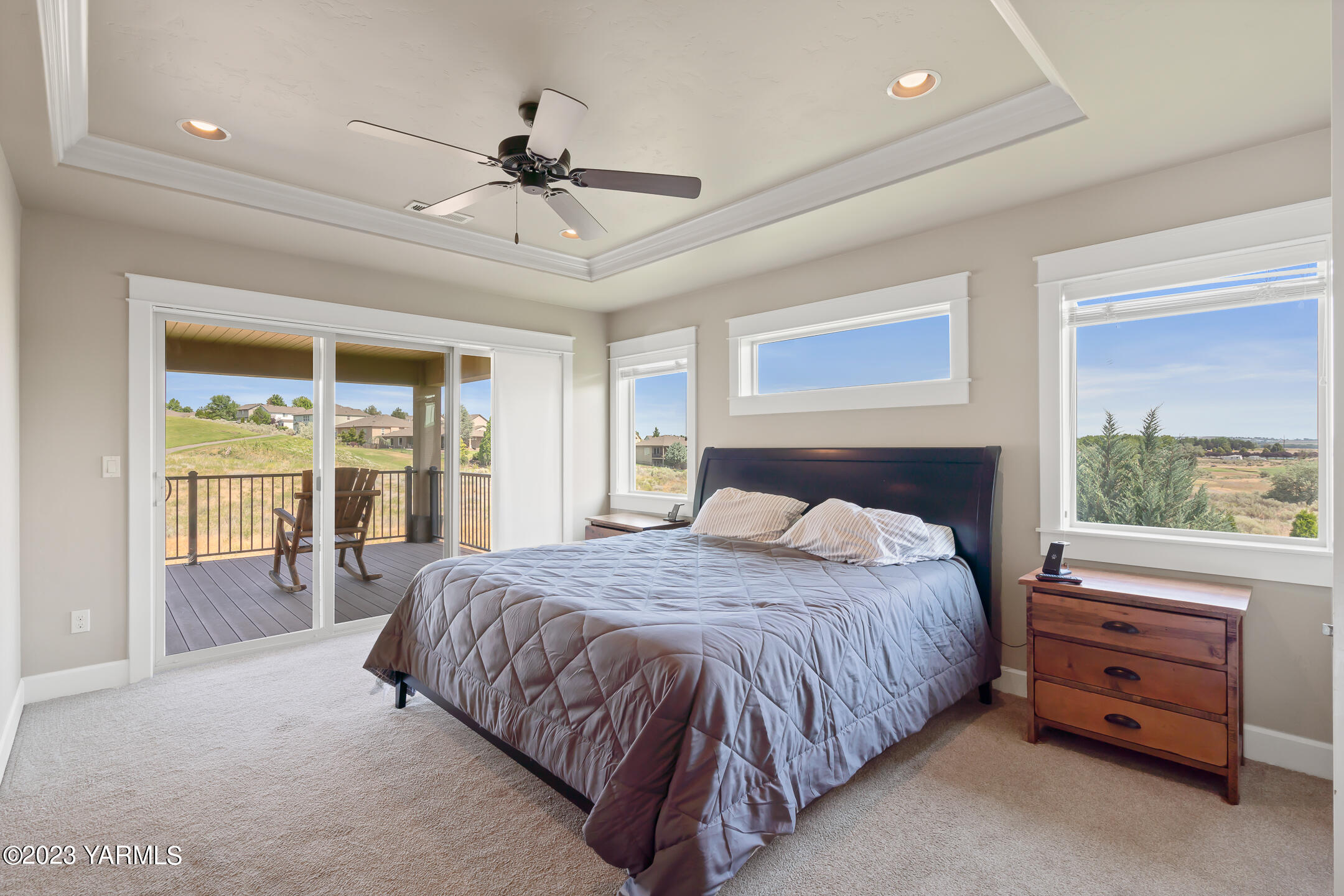 2978 Crosswater Loop Richland, WA 99354 - Photo 26 of 34 a bedroom with a bed a chandelier and a large window