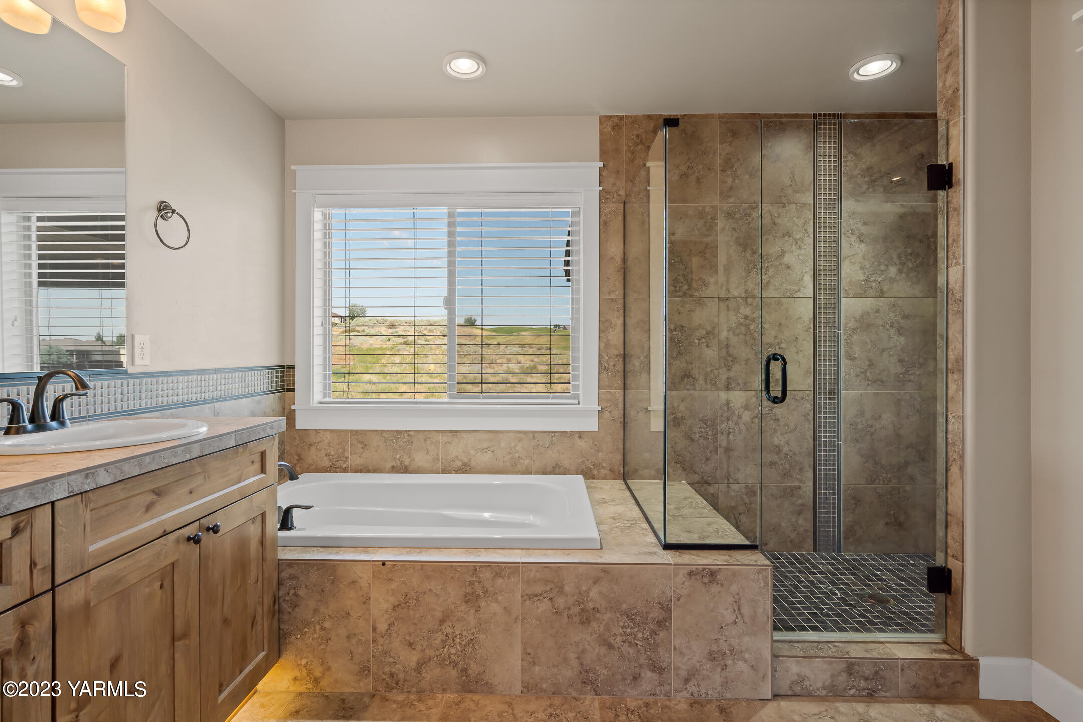 2978 Crosswater Loop Richland, WA 99354 - Photo 28 of 34 a bathroom with a granite countertop bathtub shower sink and mirror
