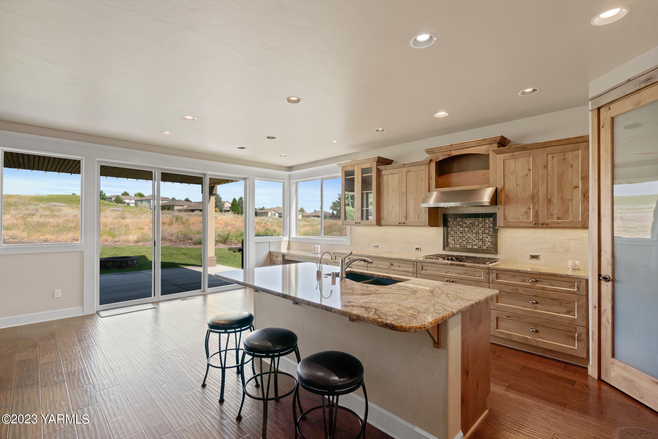 2978 Crosswater Loop Richland, WA 99354 - Photo 9 of 34 a kitchen with kitchen island a large counter top space a sink and appliances
