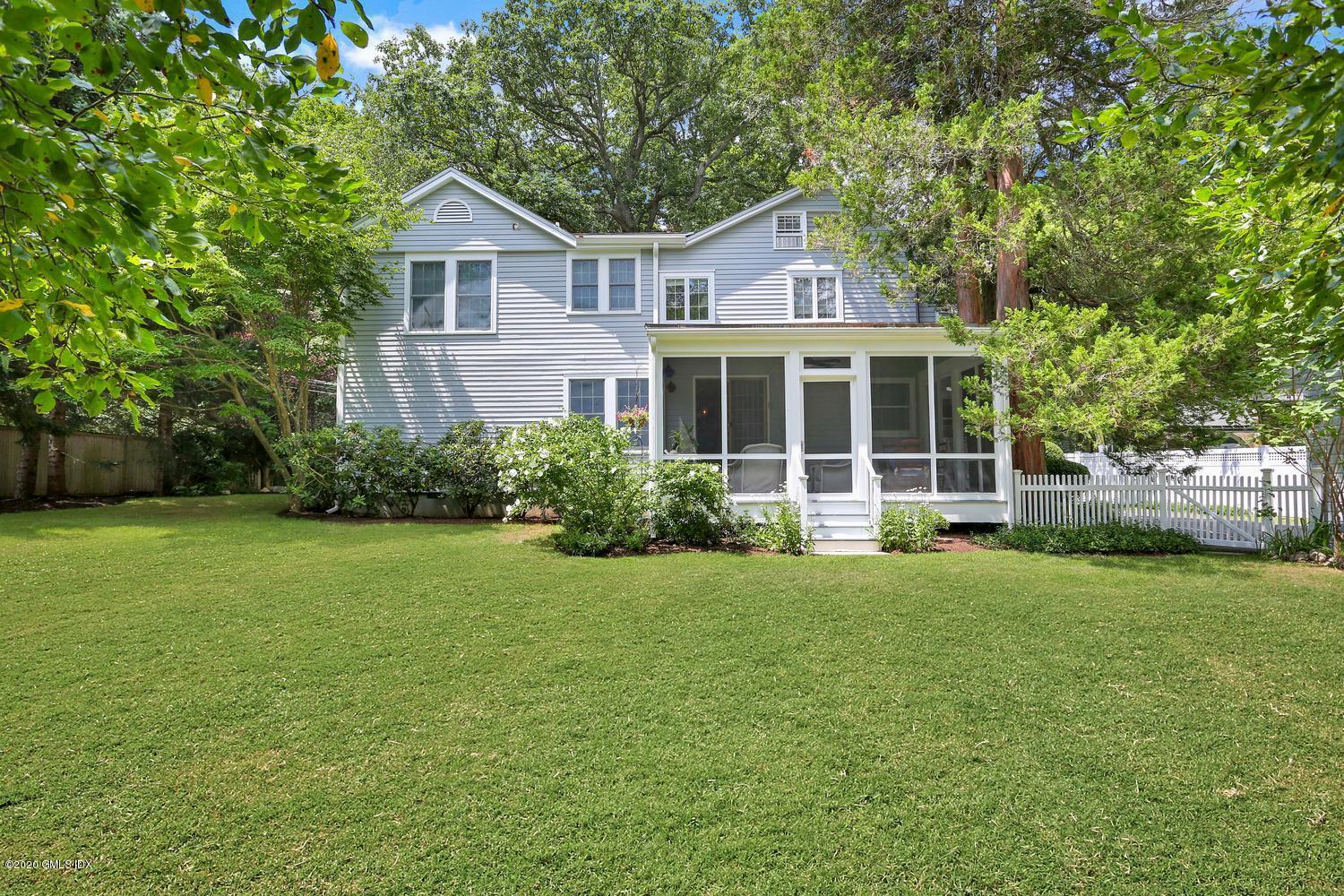 11 Indian Head Road Riverside, CT 06878 - Photo 25 of 30 a view of a big house with a big yard and large trees