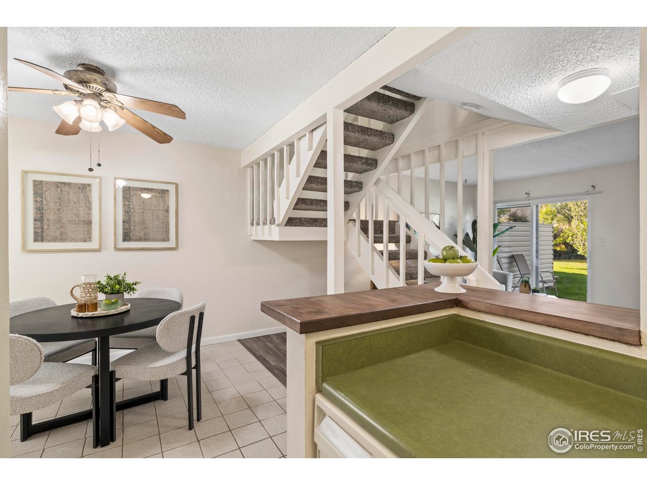 1705 Heatheridge Road, Unit E101 Fort Collins, CO 80526 - Photo 12 of 23 a view of a dining room with furniture and a window