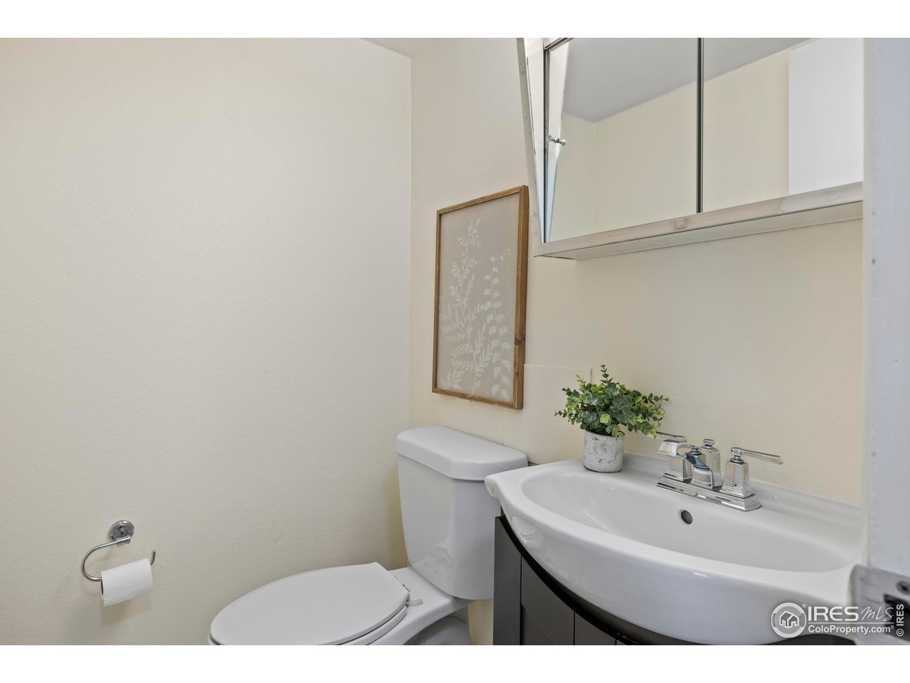 1705 Heatheridge Road, Unit E101 Fort Collins, CO 80526 - Photo 14 of 23 a bathroom with a sink a toilet and mirror