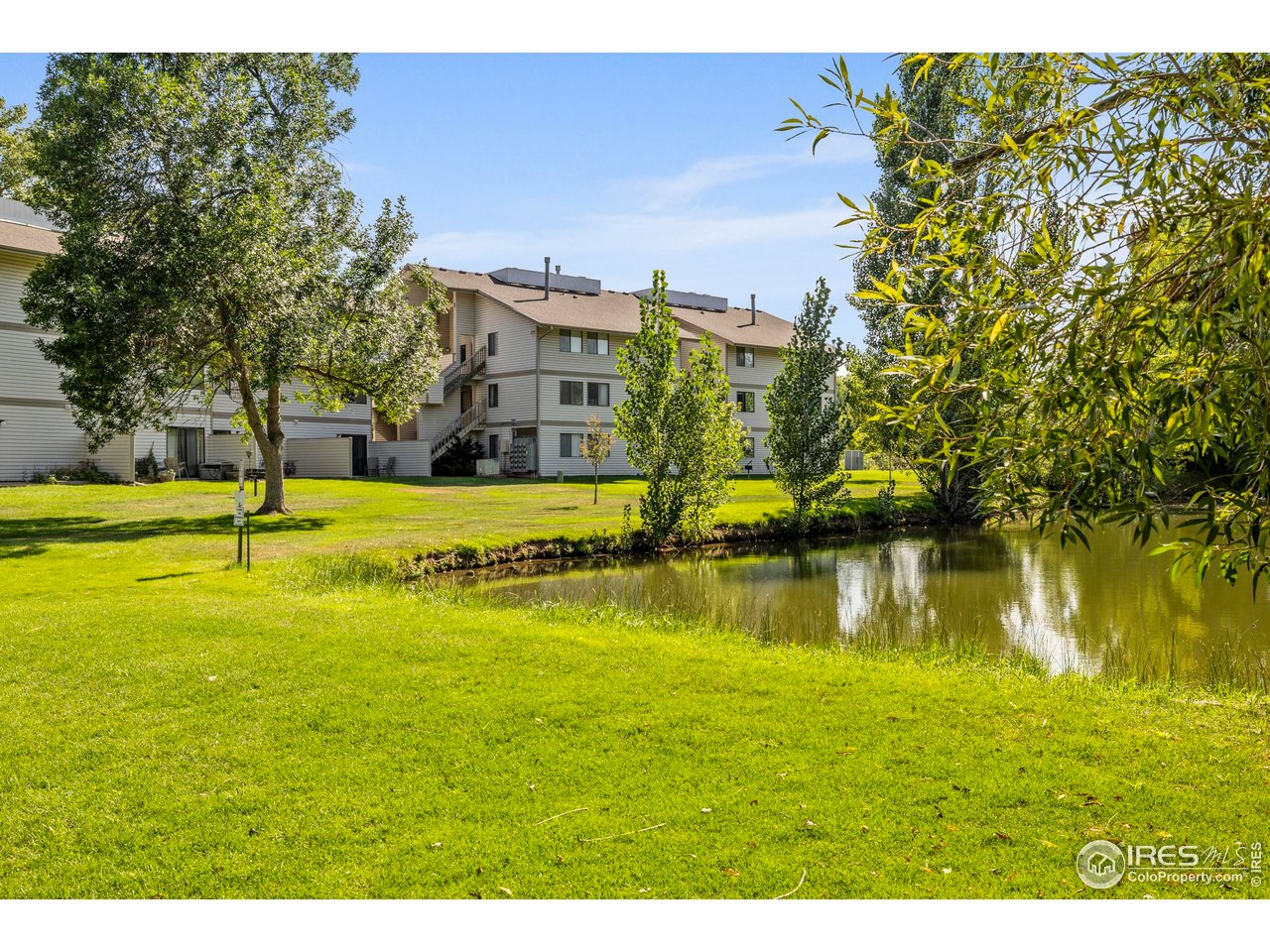 1705 Heatheridge Road, Unit E101 Fort Collins, CO 80526 - Photo 6 of 23 a view of an ocean with a building in the background