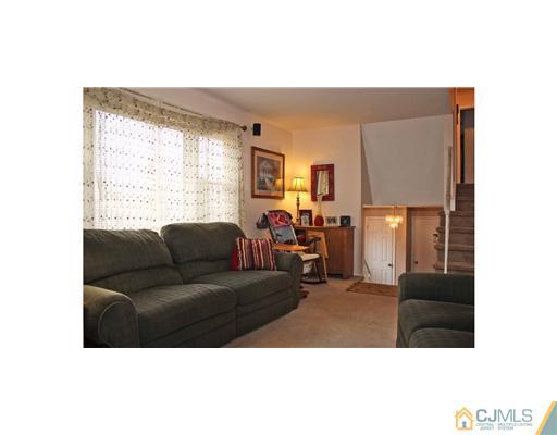 17 Monaghan Road Edison, NJ 08817 - Photo 2 of 25 a living room with furniture and a large window