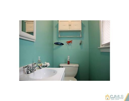 17 Monaghan Road Edison, NJ 08817 - Photo 12 of 25 a bathroom with a sink and a mirror