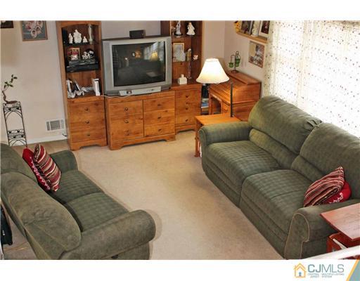 17 Monaghan Road Edison, NJ 08817 - Photo 14 of 25 a living room with furniture and a flat screen tv