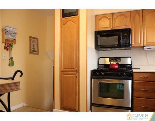 17 Monaghan Road Edison, NJ 08817 - Photo 19 of 25 a kitchen with stainless steel appliances granite countertop a stove top oven microwave and sink