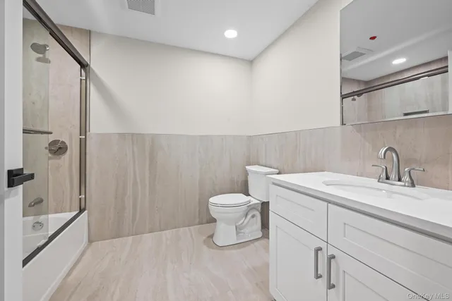 a bathroom with a toilet sink and shower