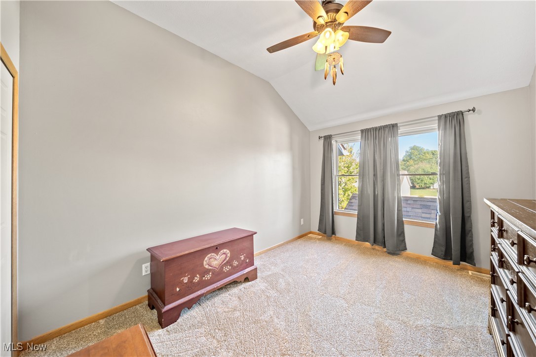 1951 Haines Road Madison, OH 44057 - Photo 25 of 44 Bedroom with ceiling fan, lofted ceiling, and carpet flooring