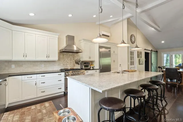 a kitchen with stainless steel appliances granite countertop a stove a sink and a refrigerator