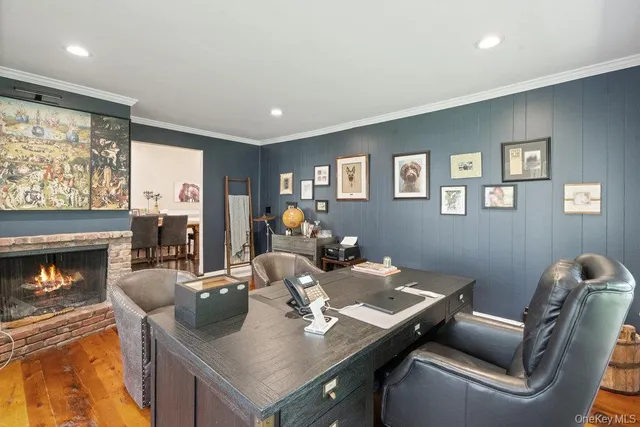 a view of a dining room with furniture and a fireplace