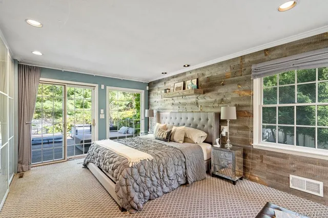 a bedroom with a large bed and a large window