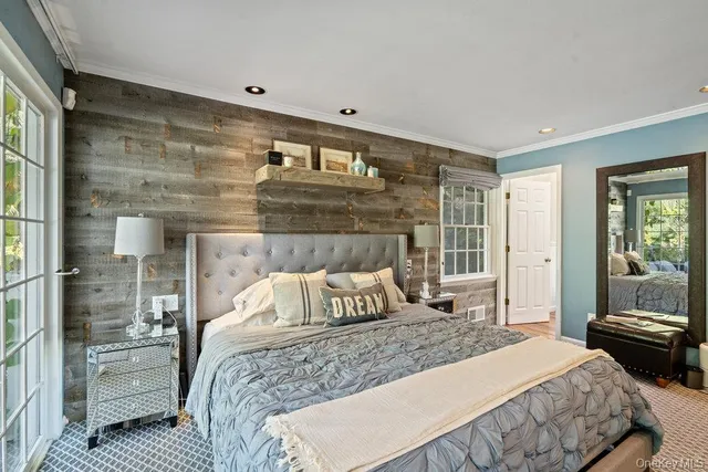 a bedroom with a large bed and a window