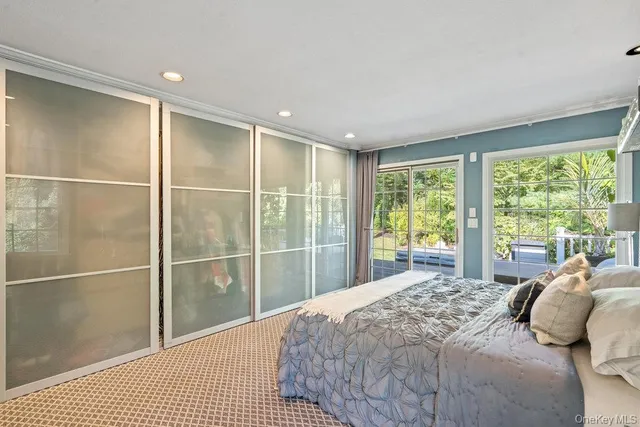 a bedroom with a large bed and a large window