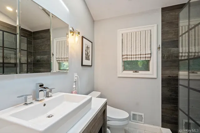 a bathroom with a sink toilet and shower