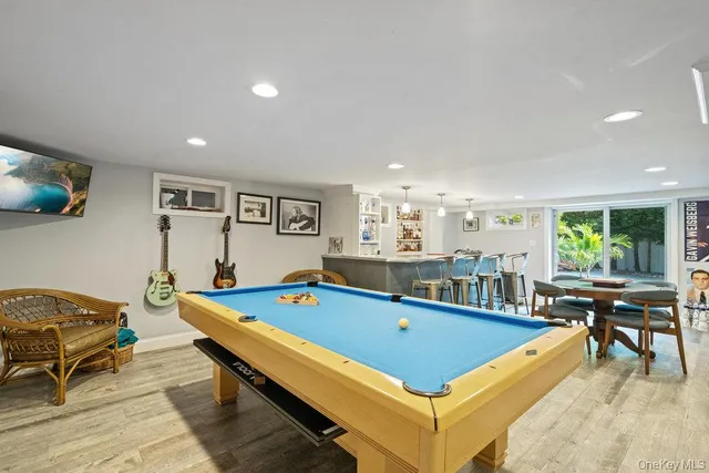 a room with furniture pool table and windows