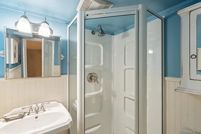 a bathroom with a shower and a sink