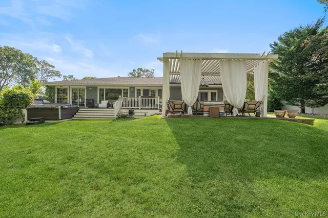 a front view of a house with a garden and trees