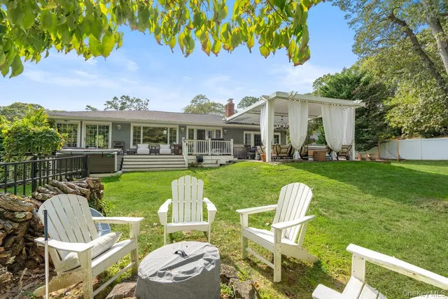 a view of a house with a yard and furniture