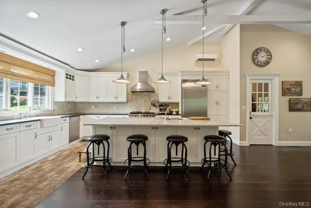 a kitchen with a table chairs stove and cabinets