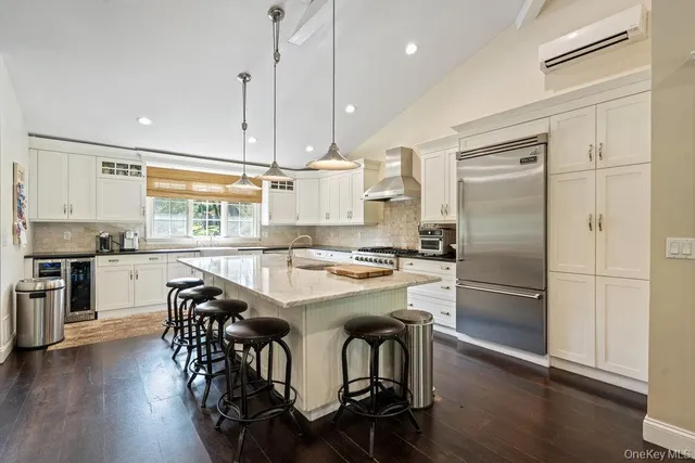 a kitchen with a table chairs refrigerator and microwave