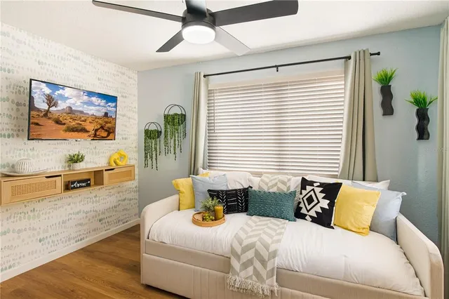 a spacious bedroom with a large bed and a flat screen tv