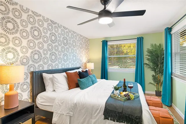 a bedroom with a bed and wooden floor