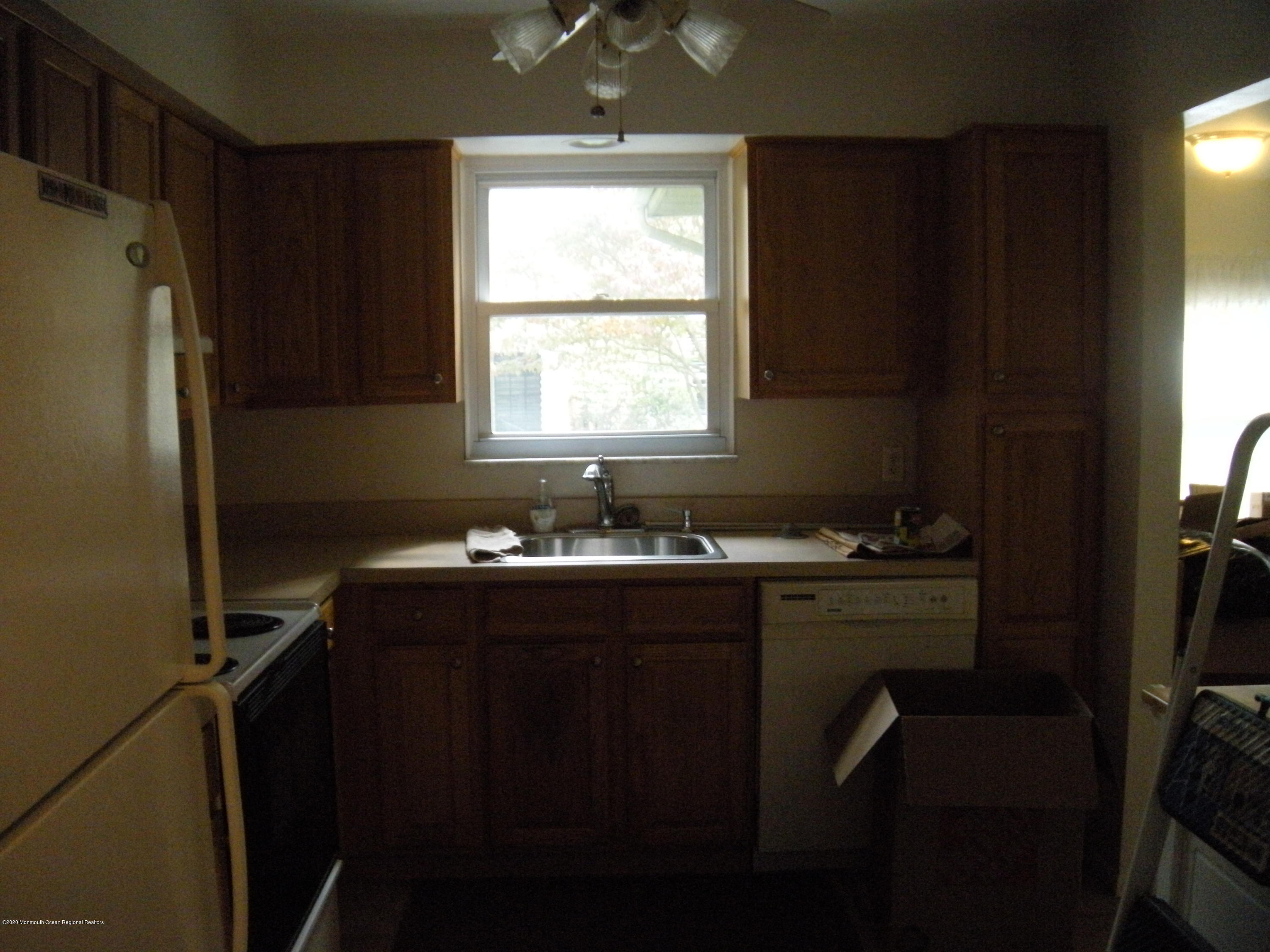 143B Sunset Road, Unit B Whiting, NJ 08759 - Photo 4 of 9 a kitchen with a window a sink cabinets and a refrigerator