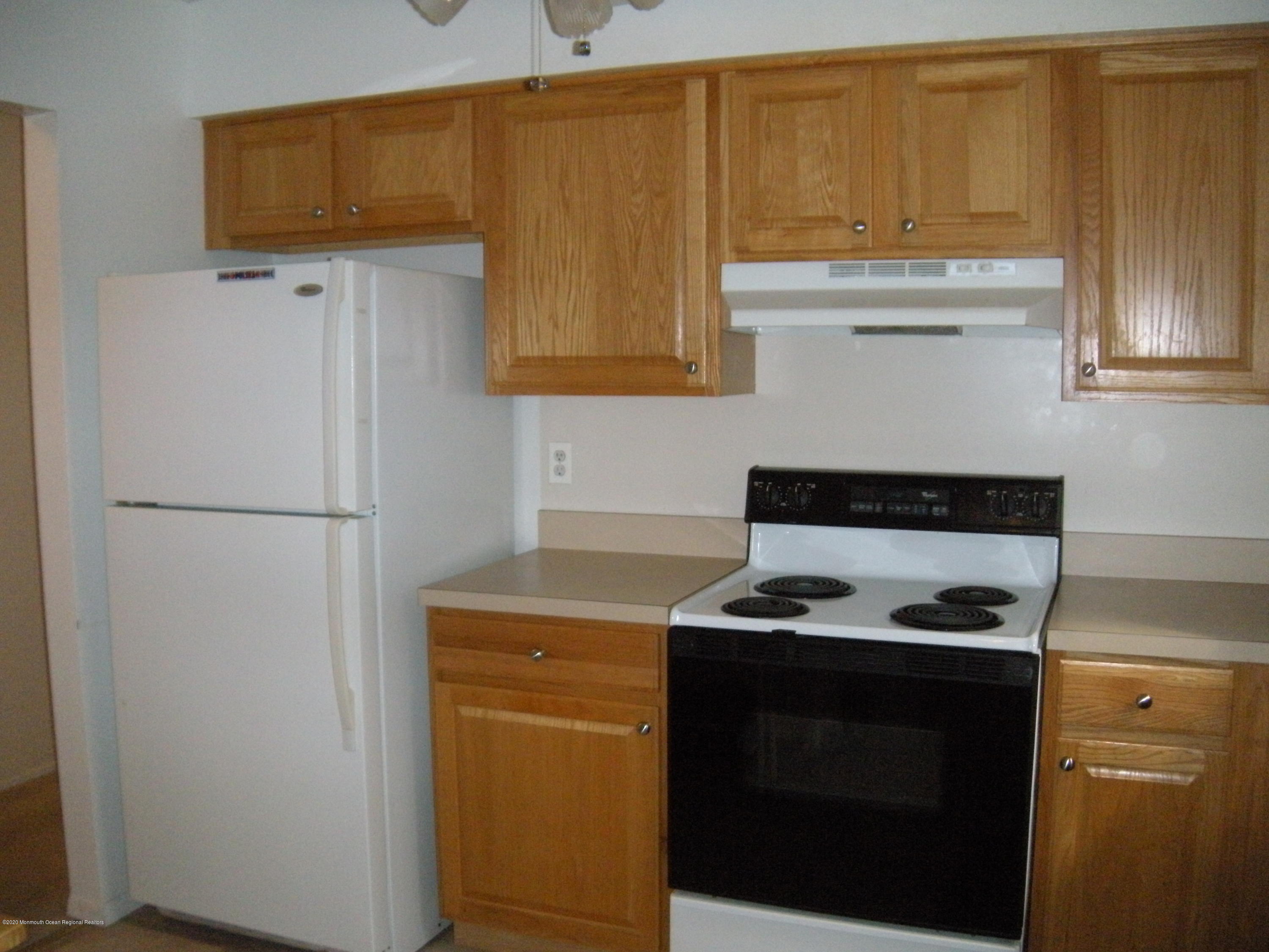 143B Sunset Road, Unit B Whiting, NJ 08759 - Photo 5 of 9 a kitchen with a refrigerator and a stove
