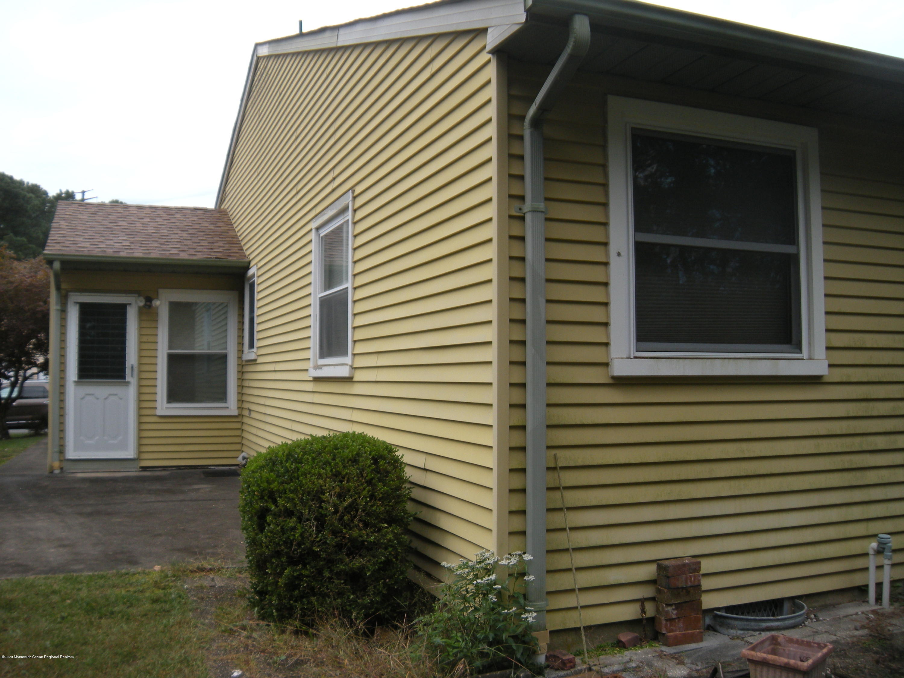 143B Sunset Road, Unit B Whiting, NJ 08759 - Photo 9 of 9 a view of a house with a window and a yard