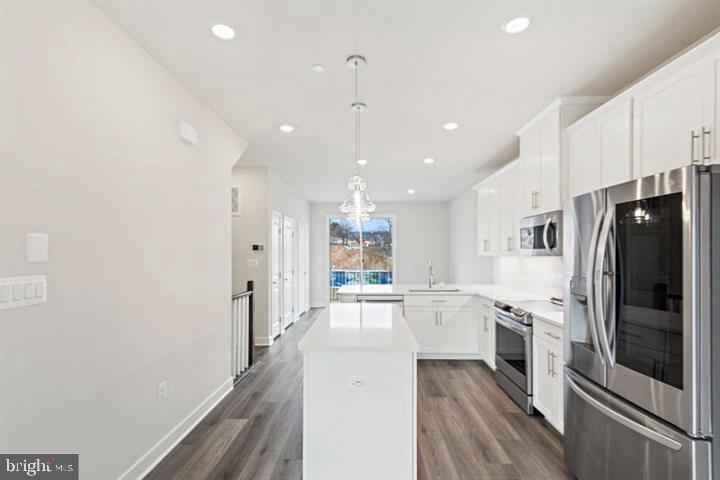 1343 Aspen Street Northwest Washington, DC 20012 - Photo 12 of 24 a kitchen with stainless steel appliances granite countertop a refrigerator a oven a sink dishwasher and white cabinets with wooden floor
