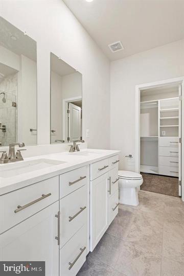 1343 Aspen Street Northwest Washington, DC 20012 - Photo 17 of 24 a bathroom with a double vanity sink a toilet and a mirror