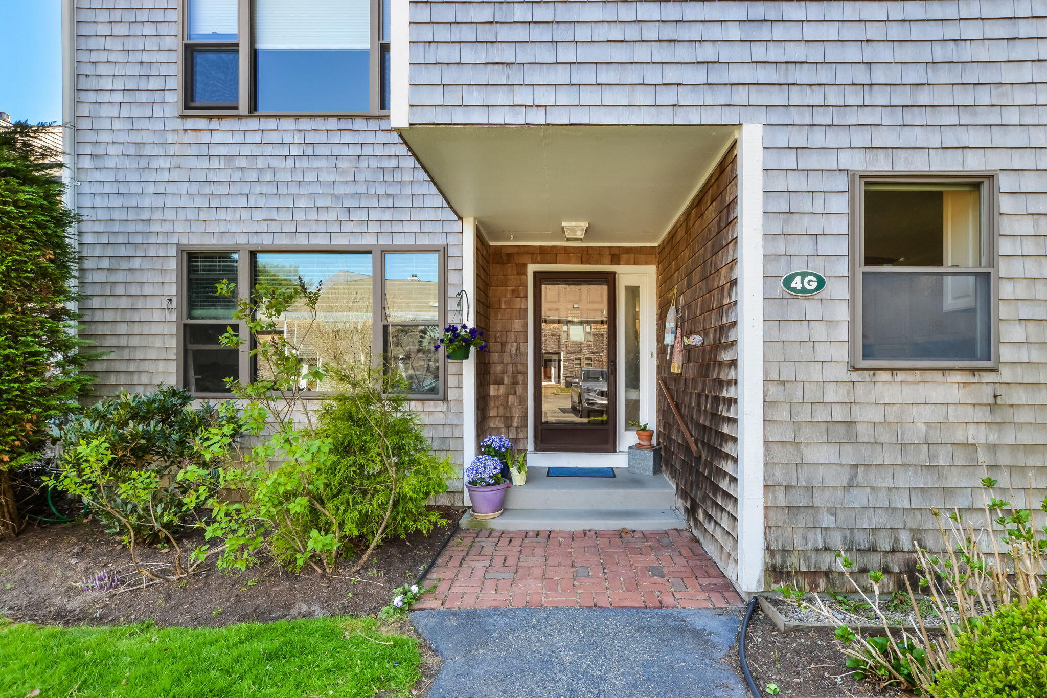 a view of brick house with a yard
