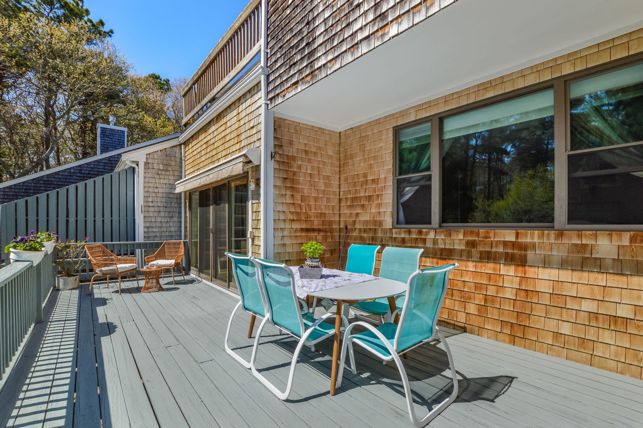 4 Riverview Avenue, Unit G Mashpee, MA 02649 - Photo 16 of 39 a view of a patio with table and chairs with wooden floor and fence