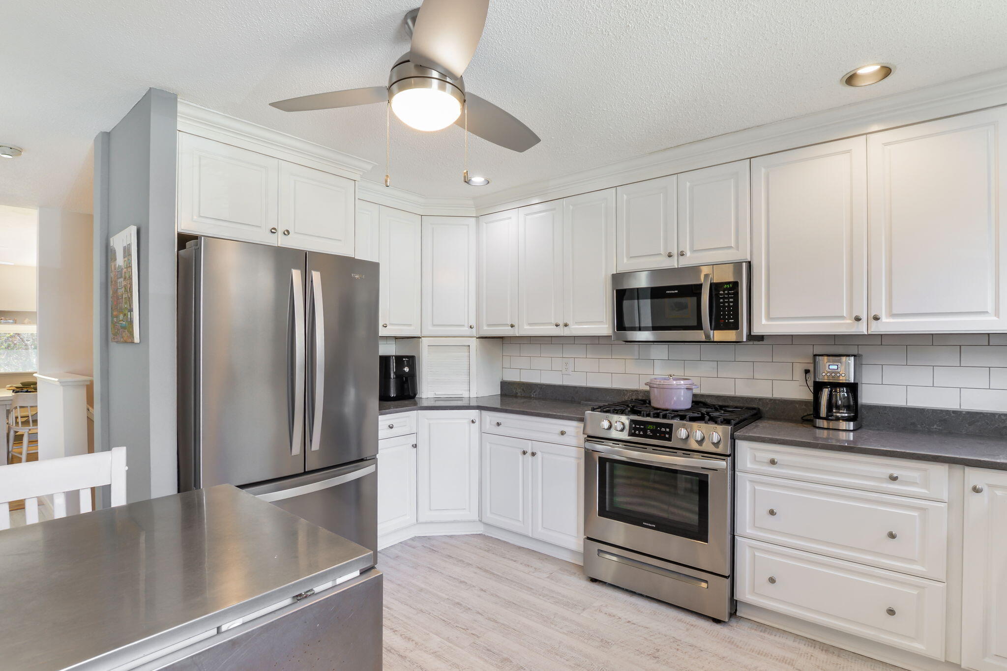 4 Riverview Avenue, Unit G Mashpee, MA 02649 - Photo 3 of 39 a kitchen with white cabinets stainless steel appliances and sink