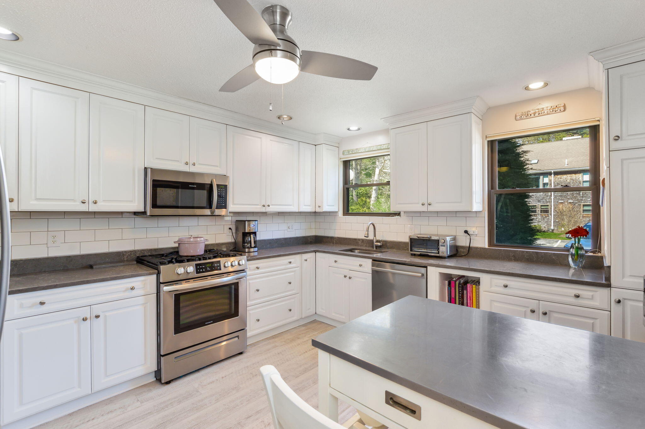 4 Riverview Avenue, Unit G Mashpee, MA 02649 - Photo 5 of 39 a kitchen with cabinets stainless steel appliances a sink and a window