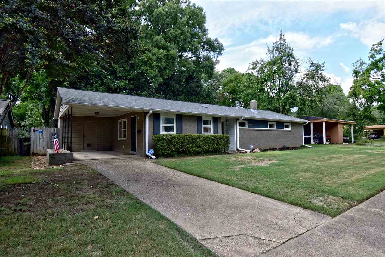 1065 Ivy Road Memphis, TN 38117 - Photo 2 of 20 a front view of a house with a yard and trees