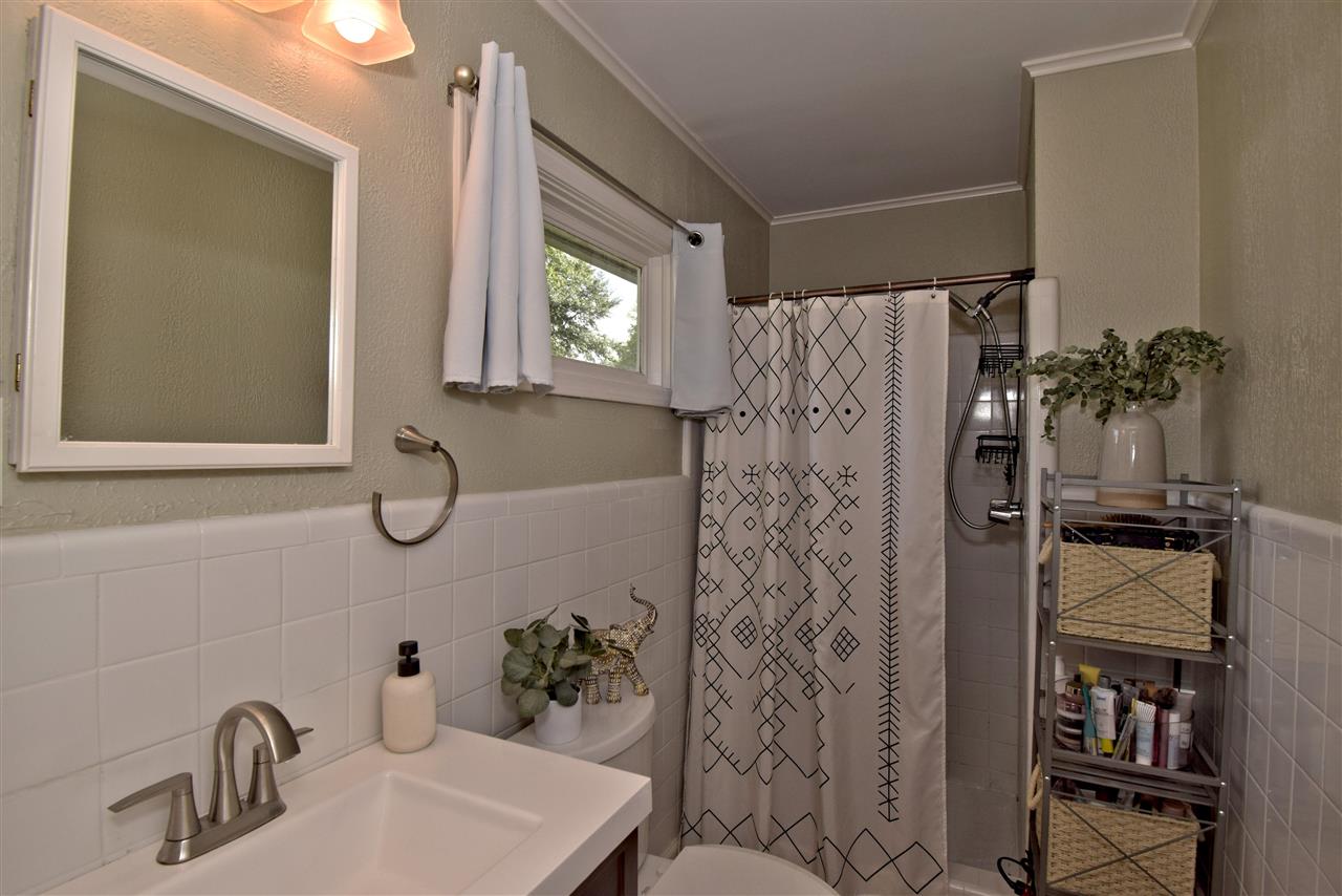 1065 Ivy Road Memphis, TN 38117 - Photo 13 of 20 a bathroom with a shower sink and mirror