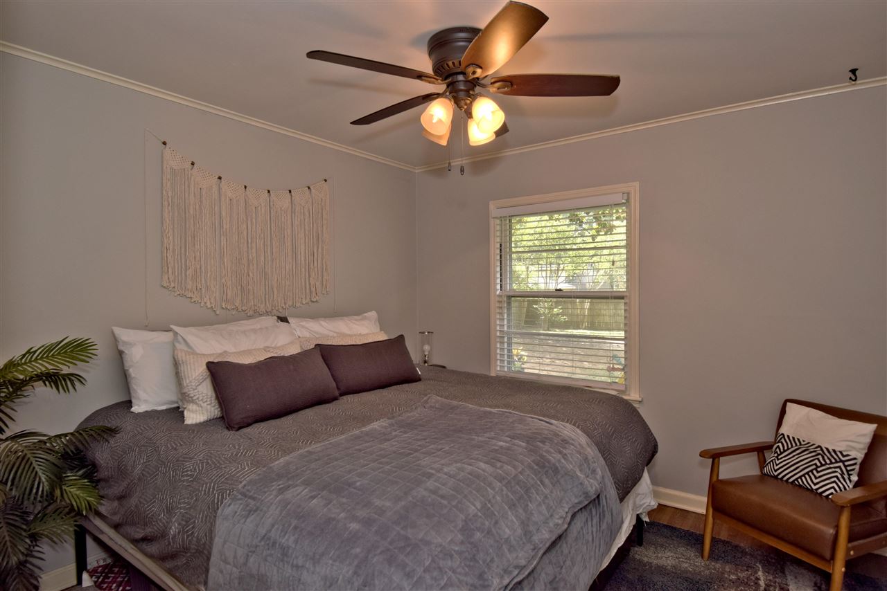 1065 Ivy Road Memphis, TN 38117 - Photo 14 of 20 a bedroom with a bed and a chandelier