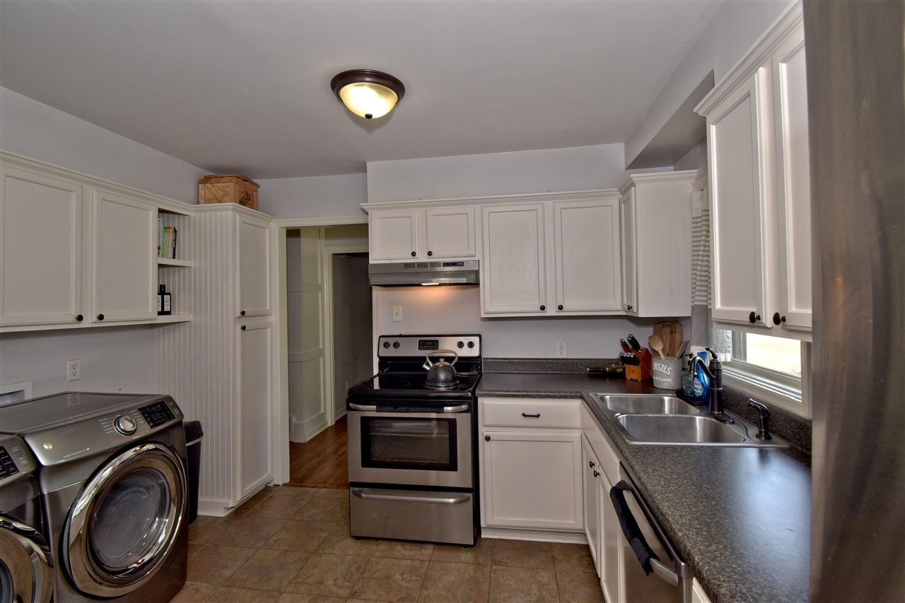 1065 Ivy Road Memphis, TN 38117 - Photo 10 of 20 a kitchen with a refrigerator a sink and wooden cabinets