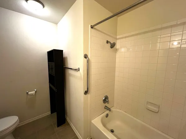 a bathroom with a bathtub and shower