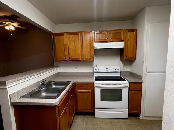 a kitchen with a sink and a stove top oven