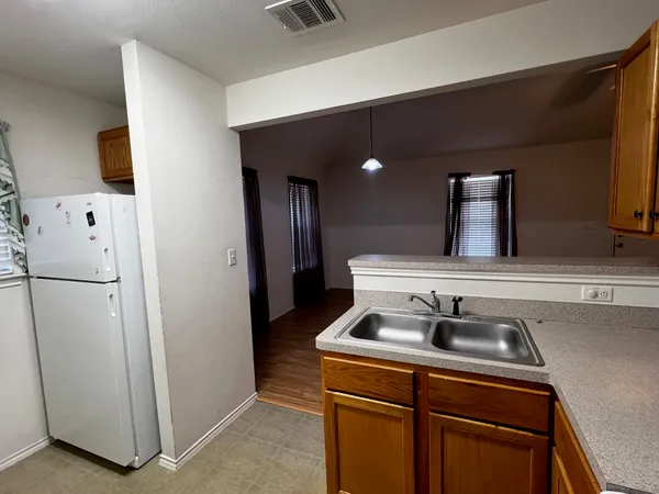 a kitchen with a refrigerator and a sink