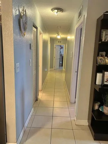 a bathroom with a granite countertop sink a toilet a mirror and shower